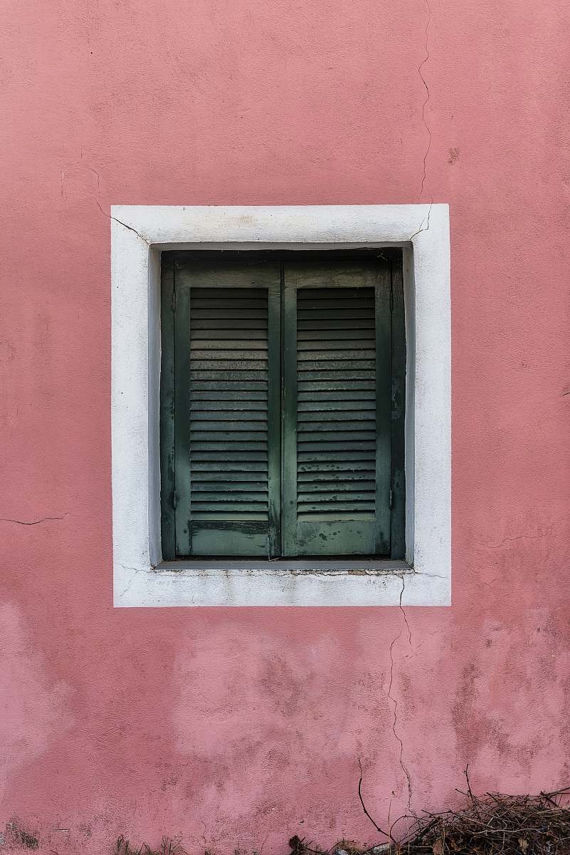 window two green wooden louvered doors curtain